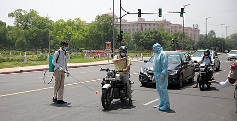 Police personnel wearing PPE suit checking the documents of a commuter in New Delhi. This image is used for representational purposes. (Photo | Shekhar Yadav, EPS)