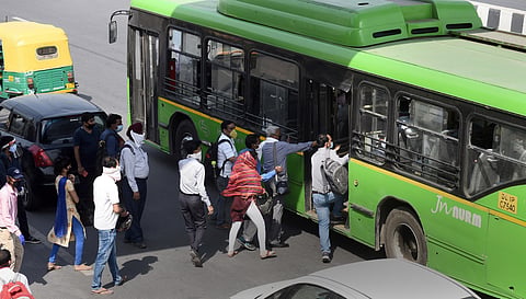 Office workers board DTC busses at Akshardham as the Delhi Government resumed bus services within the city on Tuesday. (Photo | Parveen Negi/EPS)