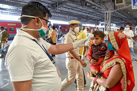 Migrants undergo thermal screening before they board a special train to Bihar during the ongoing COVID-19 lockdown in Bikaner Tuesday May 19 2020. (Photo | PTI)