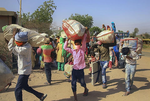 Migrants shift to a shelter home in a village before leaving for their native places in special buses arranged by the Rajasthan government during ongoing COVID-19 lockdown in Jaipur May 21 2020. (Photo | PTI)