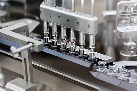 Rubber stoppers are placed onto filled vials of the investigational drug remdesivir at a Gilead manufacturing site in the United States. (File photo| AP)