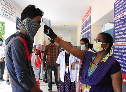 Health officials checking a person for COVID-19 symptoms. (File Photo | EPS)