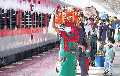 Chhattisgarh labourers head to board a special train from Bhubaneswar New Railway Station on Sunday I Express