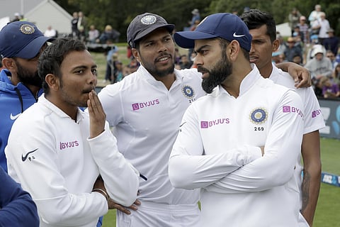 Indian Test captain Virat Kohli, right, talks with his teammates. (Photo | AP)