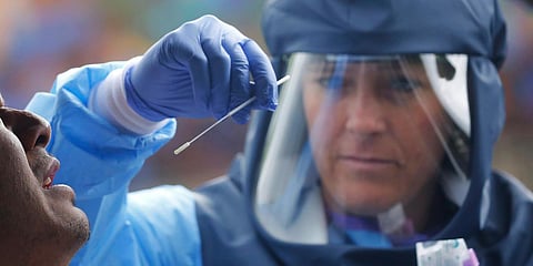 Salt Lake County Health Department public health nurse Lee Cherie Booth performs a coronavirus test outside the Salt Lake County Health Department. (File Photo | AP)