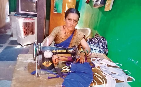 An anganwadi worker stitches masks for free distribution in Ron taluk | Express