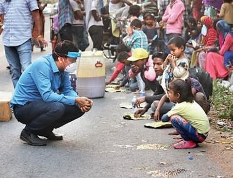 Dr Prasun Chatterjee of AIIMS interacting with a child in New Delhi | express