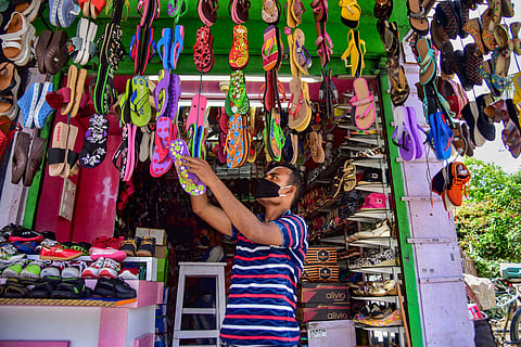 A shopkeeper arranges shoes at his store as he waits for customers after authorities eased restrictions during the ongoing COVID-19 nationwide lockdown in Nagaon district, Assam May 4 2020. (Photo | PTI)