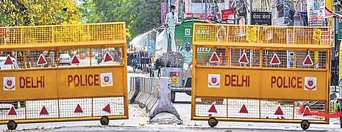 A containment zone being sanitised by corporation workers | express