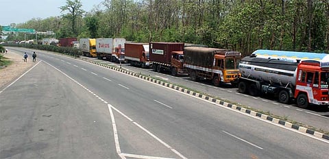 Trucks making a beeline on Kochi-Salem National Highway to cross the Walayar checkpost, on the outskirts of Coimbatore. (Photo | EPS)