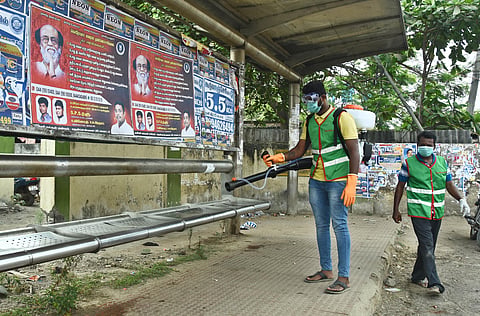 Chennai Corporation officials work at Pallikaranai Bus stop on the day of Janata Curfew. (Photo | Ashwin Prasath, EPS)