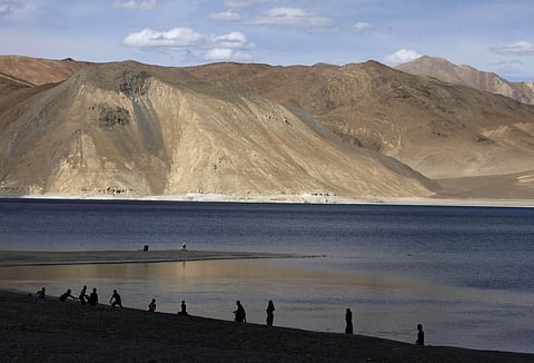 People stand by the banks of the Pangong Lake, near the India-China border in Ladakh, India. (File Photo | AP)