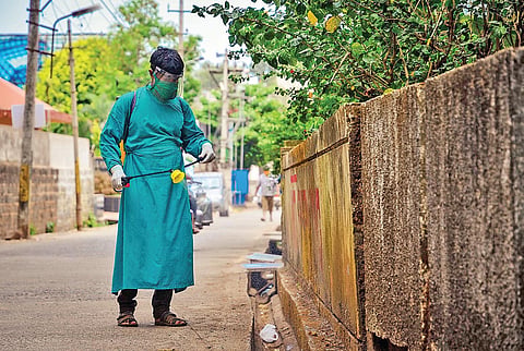 (Image used for representation) A sanitation worker sprays disinfectant. (File Photo | EPS)
