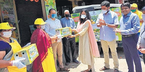 CMC Commissioner Ananya Das handing over mango cartons to customers I EXPRESS