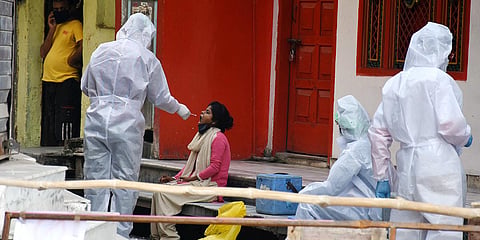A medical team collects a swab sample of a COVID-19 suspect in Lucknow. (Photo| ANI)