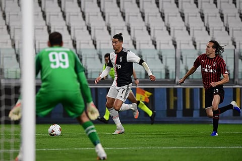 Juventus' Portuguese forward Cristiano Ronaldo (C) outruns AC Milan's Uruguayan midfielder Diego Laxalt. (Photo| AFP)