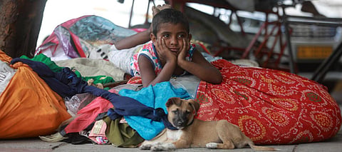 A child of stranded migrant worker take rest on luggage during the 4th phase of nationwide lockdown in Delhi. (File Photo| Shekhar Yadav, EPS)