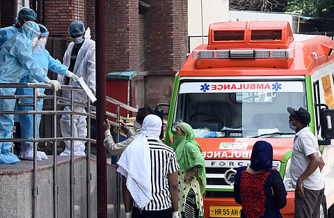 Medical workers in PPE gear interacting with visitors outside the Covid-19 ward at Lok Nayak Jai Prakash Narayan Hospital. (Photo | Parveen Negi, EPS)