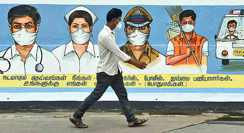 Man walks past a graffiti in appreciation of Corona Warriors. (Photo | Ashwin Prasath, EPS)EPS)