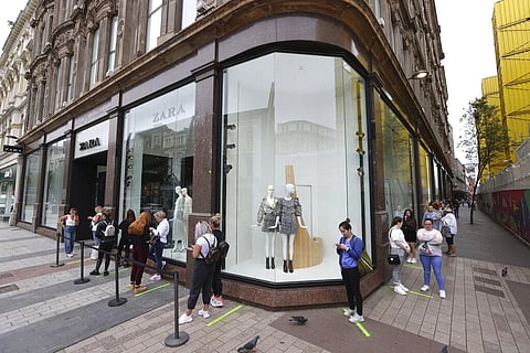 Shoppers queue outside Zara in Belfast, northern Ireland, Monday, June 15, 2020. After three months of being closed under coronavirus restrictions, shops selling fashion, toys and other non-essential goods are being allowed to reopen across England for th