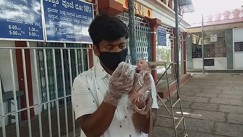 Prasanna Kumar takes care of a baby monkey that was rescued