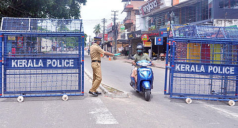 A policeman stopping and asking a two-wheeler rider to go back as he come from the containment zone, in Thiruvananthapuram. (Photo | Vincent Pulickal, EPS)