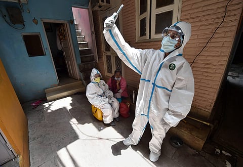 A medic collects blood samples for serological survey to analyse the spread of COVID-19 at Paharganj in New Delhi Saturday June 27 2020. (Photo | PTI)