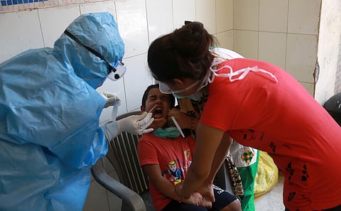 A health official collects a swab sample from a child during the Government conduct rapid antigen COVID-19 tests at Lado sarai in New Delhi on Friday. (Photo | EPS/Shekhar Yadav)
