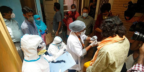 A medic takes blood samples from a resident during a door-to-door COVID-19 survey in New Delhi. (Photo| Shekhar Yadav, EPS)