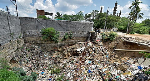 Heaps of garbage mar the historic well near Toli Masjid in Hyderabad. (Photo| S Senbagapandiyan, EPS)