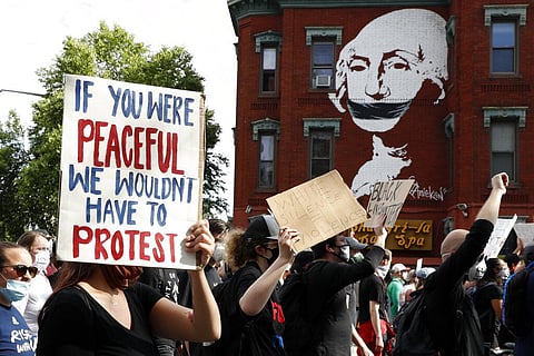 In this June 2, 2020, file photo, demonstrators march to protest the death of George Floyd in Washington. Floyd died after being restrained by Minneapolis police officers. (Photo | AP)