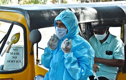Dilip Kumar auto driver from velachery wearing PPE suit and driving his auto for customers safety and creating an awareness among other auto drivers in the city. (Photo | Ashwin Prasath/EPS)
