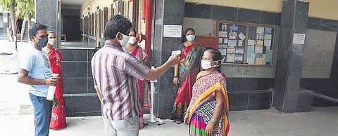 Staff of a private school undergo thermal screening in Hyderabad on Thursday as schools are getting ready to conduct the remaining Class 10 examinations |RVK Rao