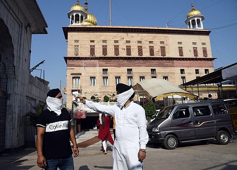 A sikh devotee being screened with thermal device at Sis Ganj Gurudwara during the ongoing COVID-19 nationwide lockdown in New Delhi on Sunday June 7 2020. (Photo | Parveen Negi/EPS)