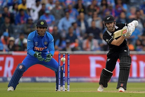 New Zealand's captain Kane Williamson (R) plays a shot as India's wicketkeeper Mahendra Singh Dhoni looks on during the 2019 Cricket World Cup first semi-final. (Photo | AFP)