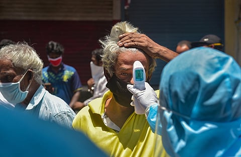 Volunteers conduct thermal screening at Dharavi during the ongoing COVID-19 lockdown in Mumbai Sunday June 7 2020. (Photo | PTI)