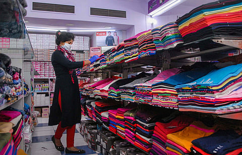 A salesperson arranges products on display at a shop inside Shopprix Mall after it reopened in Noida Monday June 8 2020. (Photo | PTI)