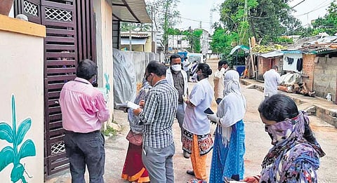 Civic body officials conducting household survey at Nayapalli in Bhubaneswar on Tuesday (Photo | EPS)