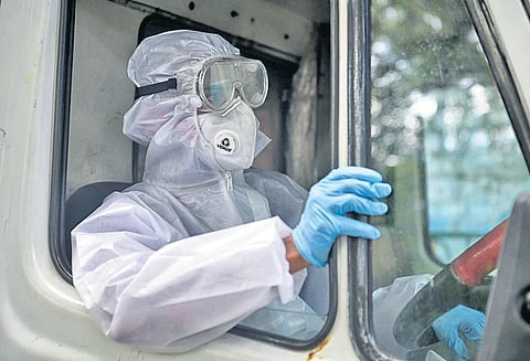 An ambulance driver starts duty in Bengaluru early on Thursday morning | Express