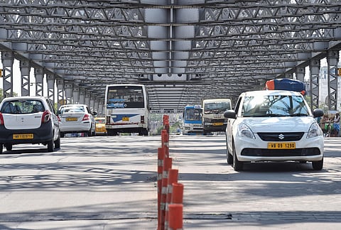 Vehicles cross the Howrah bridge during the ongoing COVID-19 nationwide lockdown in Kolkata. (Photo | PTI)