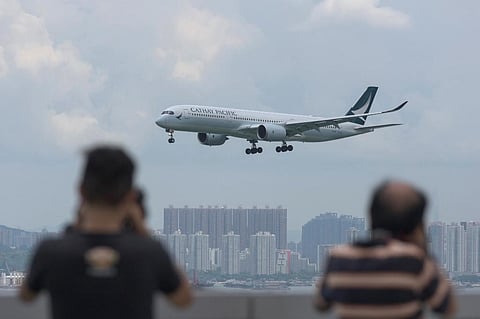A Cathay Pacific passenger plane making its descent before landing at Hong Kong's international airport. (Photo| AFP)