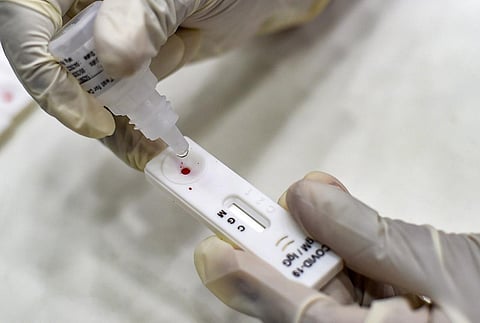 A health worker collects a sample for a for COVID-19 Rapid Antigen test (Photo | PTI)