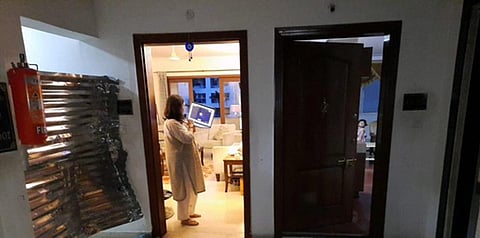 Hours after it sealed two flats in a Domlur apartment, BBMP was forced take off the tin sheets and block the corridor instead after the tweet went viral | pic source: Twitter