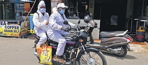 Sanitation workers leaving after spraying disinfectant at Arumbakkam in Chennai on Tuesday | DEBADATTA MALLICK