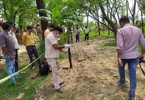 Kanpur Police and forensic team members investigate the encounter site where 8 police personnel lost their lives after being fired upon by criminals in Kanpur Friday July 3 2020. (Photo | PTI)