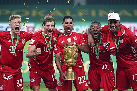 Bayern Munich players celebrate with the trophy after winning the German soccer cup (DFB Pokal) final match between Bayer 04 Leverkusen and FC Bayern Munich in Berlin, Germany. (Photo | AP)