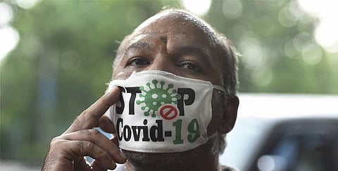 A man wearing a designer face mask is seen on a city street during Unlock 1.0 in Kolkata. (Photo | PTI)