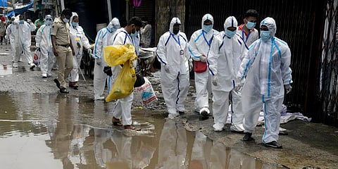 Health workers wearing PPE go to carry medical checkup of the residents of 'containment zones' at Malad in Mumbai. (Photo| PTI)