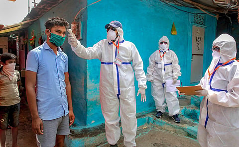 A team of doctors wearing protective suits check slum dwellers during a house-to-house health survey at Vallabh Nagar during the nationwide lockdown imposed in wake of the coronavirus pandemic in Bhopal Monday April 20 2020. (Photo | PTI)