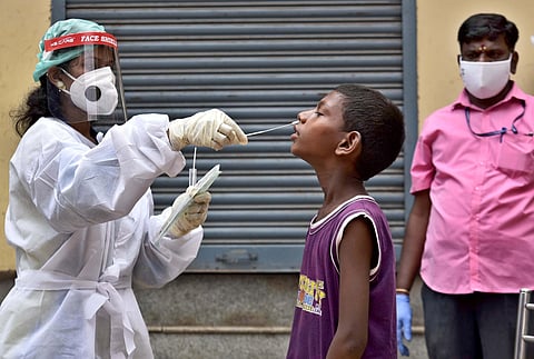 Swab test being done for COVID-19 on slum children. (Photo | P Jawahar, EPS)
